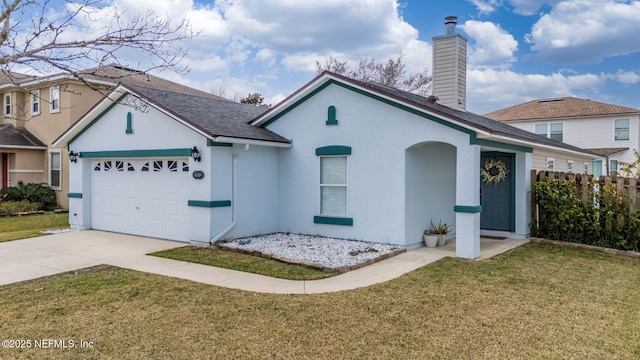 view of front of property featuring a garage and a front lawn