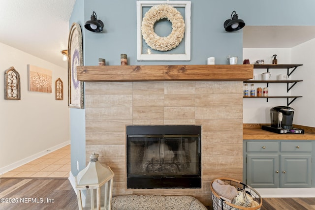 room details featuring hardwood / wood-style flooring and a tile fireplace