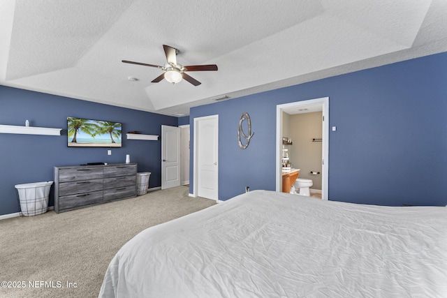 carpeted bedroom featuring ensuite bathroom, lofted ceiling, ceiling fan, and a textured ceiling