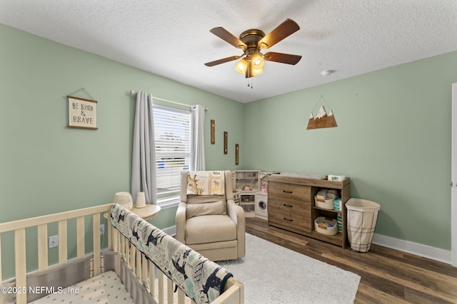 bedroom featuring dark wood-type flooring, ceiling fan, and a textured ceiling