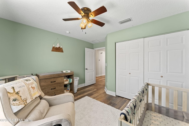 interior space featuring ceiling fan, a textured ceiling, and dark hardwood / wood-style flooring