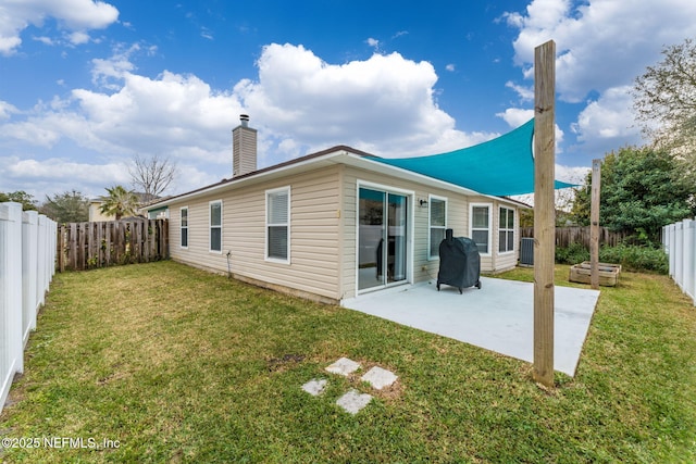 rear view of house featuring a yard, central AC, and a patio