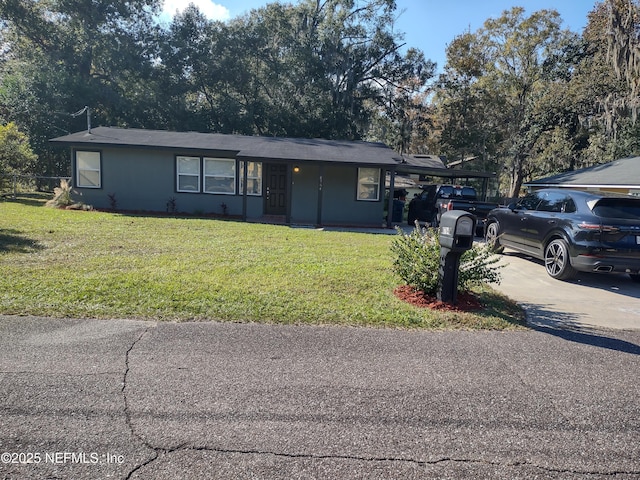 ranch-style house featuring a carport and a front yard