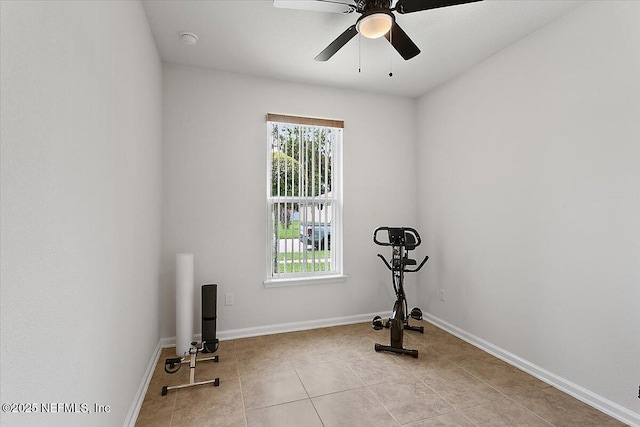 exercise area featuring ceiling fan and light tile patterned floors