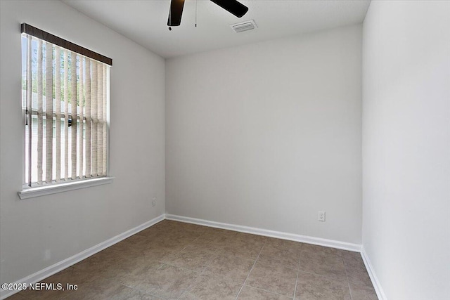 empty room with ceiling fan and a healthy amount of sunlight