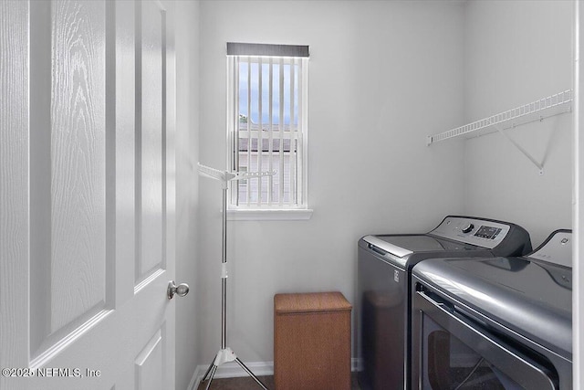 clothes washing area with washing machine and dryer