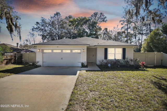 view of front of property with a yard and a garage