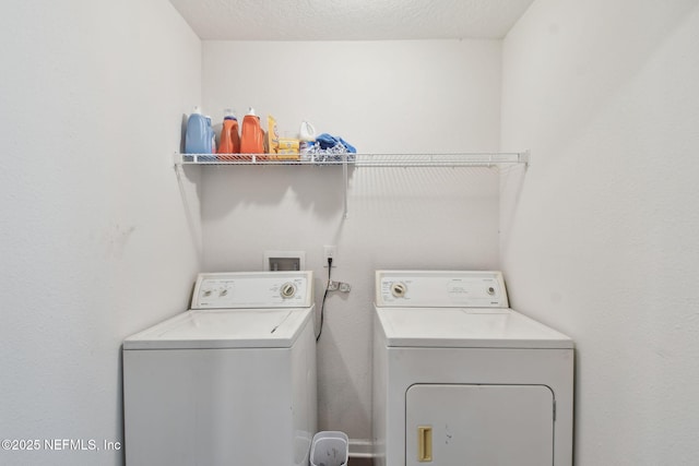 washroom featuring washer and dryer and a textured ceiling