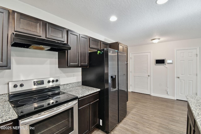 kitchen featuring light hardwood / wood-style floors, stainless steel appliances, a textured ceiling, light stone counters, and dark brown cabinetry