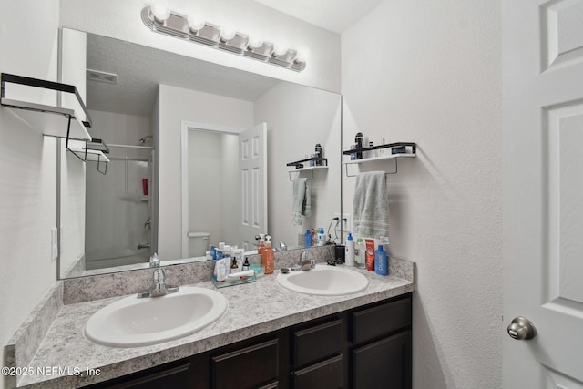 full bathroom with toilet, vanity, and shower / bath combination with glass door