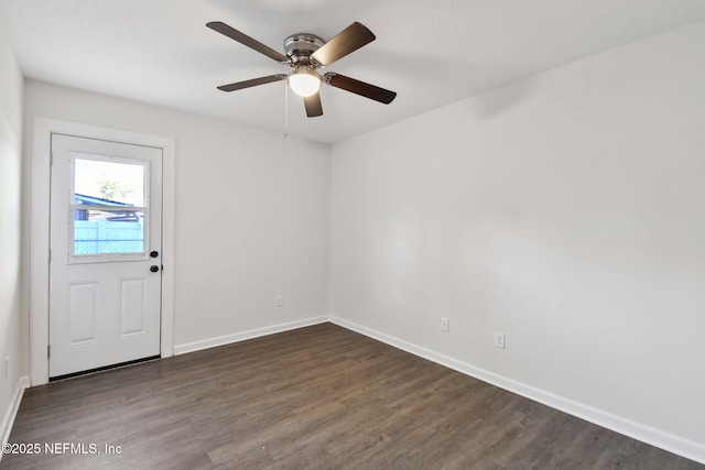 empty room featuring ceiling fan and dark wood-type flooring