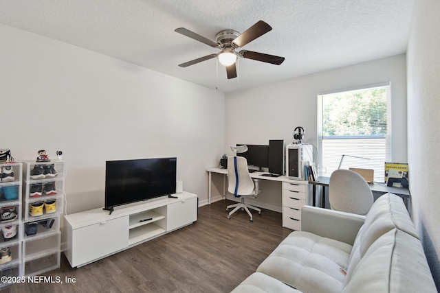 office area featuring ceiling fan, dark wood-type flooring, and a textured ceiling