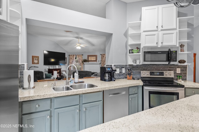 kitchen with stainless steel appliances, tasteful backsplash, sink, vaulted ceiling, and ceiling fan