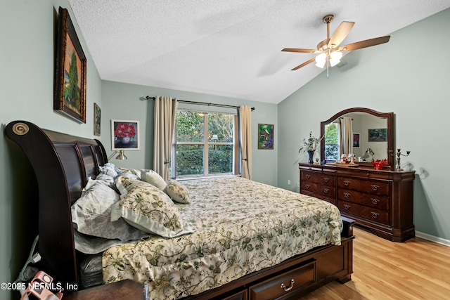 bedroom with ceiling fan, vaulted ceiling, light wood-type flooring, and a textured ceiling