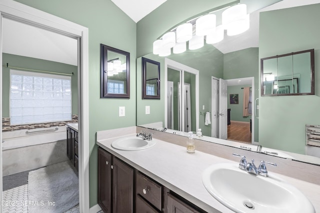 bathroom featuring vaulted ceiling and vanity