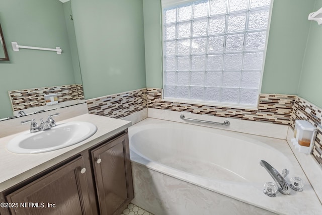 bathroom with a washtub and vanity