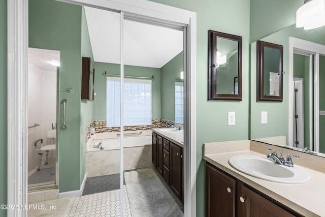 bathroom with tile patterned floors, vanity, and independent shower and bath