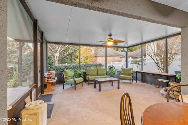 sunroom featuring ceiling fan and a healthy amount of sunlight