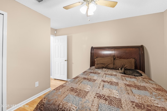 bedroom featuring ceiling fan and light hardwood / wood-style flooring