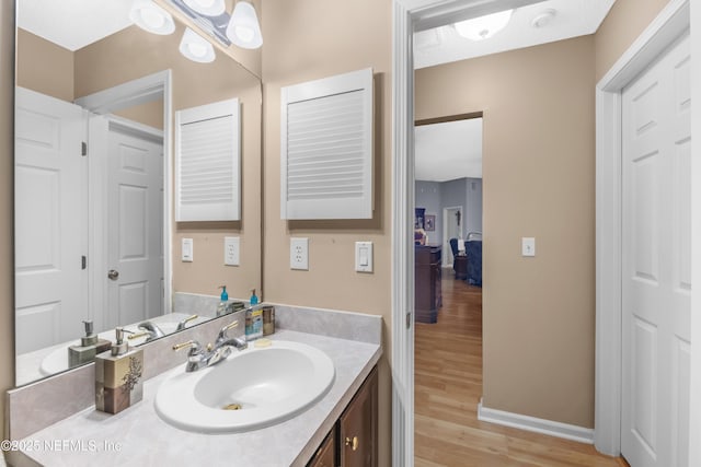 bathroom with hardwood / wood-style flooring and vanity