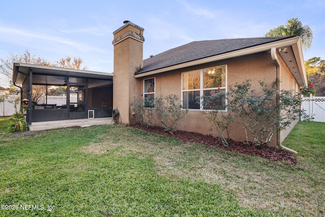 back of property featuring a patio area, a yard, and ceiling fan