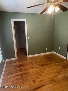 spare room featuring hardwood / wood-style floors and ceiling fan