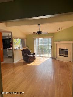 unfurnished living room featuring vaulted ceiling with beams, wood-type flooring, and ceiling fan