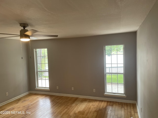 3706 Sanctuary Way N, Jacksonville Beach, FL 32250 - unfurnished room featuring light wood-type flooring, baseboards, a ceiling fan, and a textured ceiling