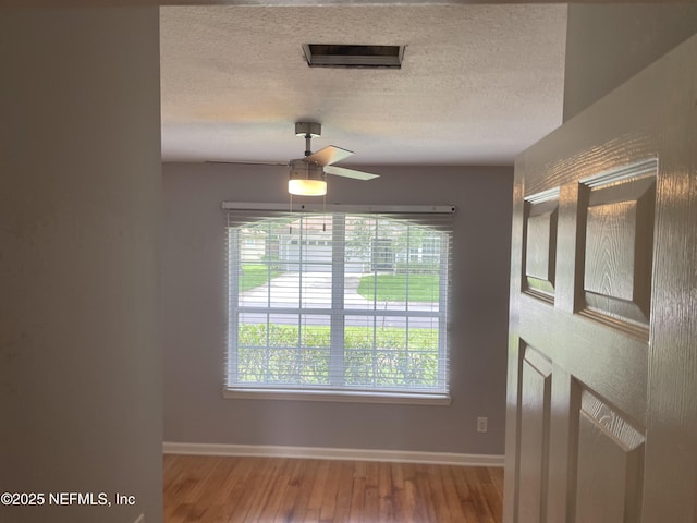 3706 Sanctuary Way N, Jacksonville Beach, FL 32250 - spare room with baseboards, a textured ceiling, wood finished floors, and a ceiling fan