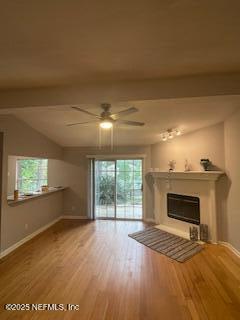 3706 Sanctuary Way N, Jacksonville Beach, FL 32250 - unfurnished living room featuring baseboards, healthy amount of natural light, wood finished floors, a ceiling fan, and lofted ceiling