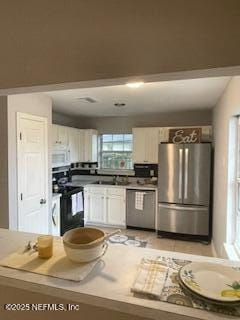 3706 Sanctuary Way N, Jacksonville Beach, FL 32250 - kitchen featuring appliances with stainless steel finishes, white cabinetry, and a sink