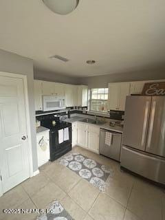3706 Sanctuary Way N, Jacksonville Beach, FL 32250 - kitchen with appliances with stainless steel finishes and light tile patterned floors