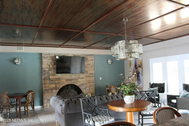 dining area with wooden ceiling and a fireplace