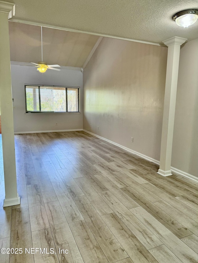 unfurnished room with ceiling fan, light hardwood / wood-style floors, ornamental molding, and vaulted ceiling