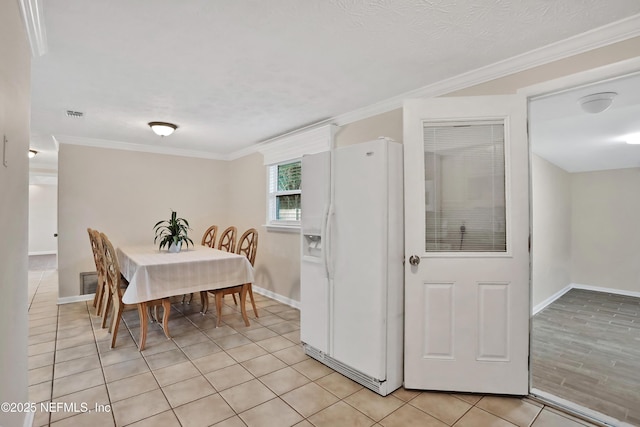 dining area with light tile patterned floors and ornamental molding