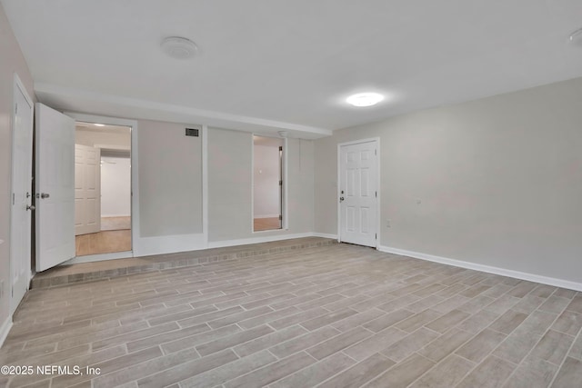 spare room featuring light hardwood / wood-style floors