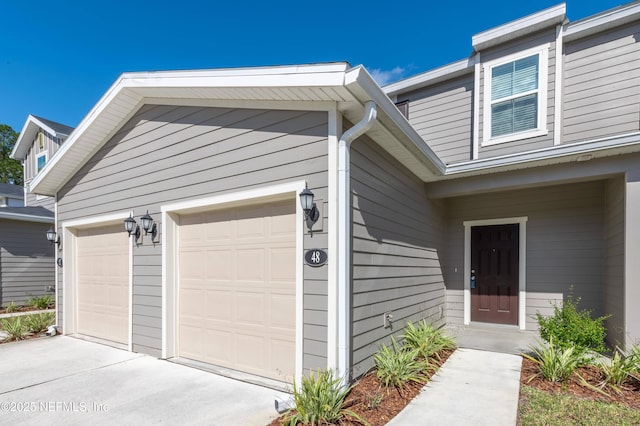 view of exterior entry with a garage