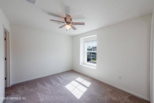 empty room featuring carpet, a textured ceiling, and ceiling fan