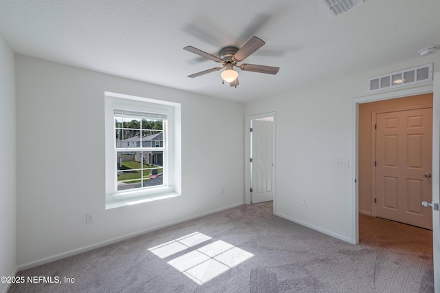 unfurnished bedroom featuring light carpet and ceiling fan