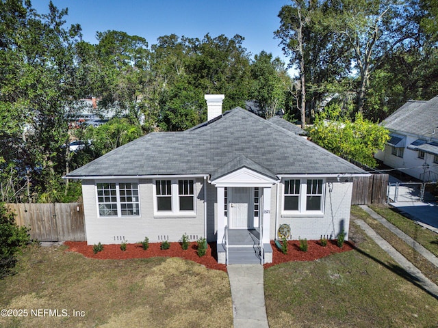 bungalow-style house with a front yard