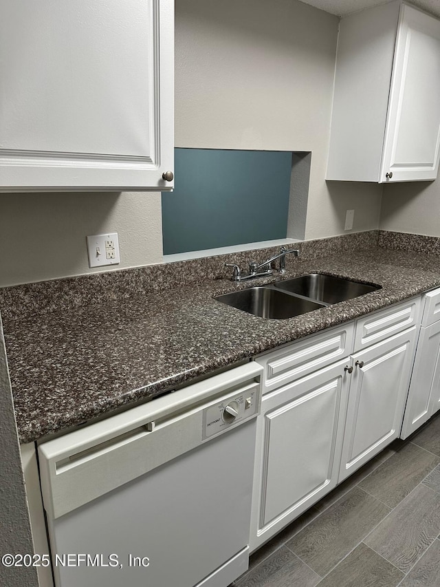 kitchen featuring sink, white cabinets, dishwasher, and dark stone countertops