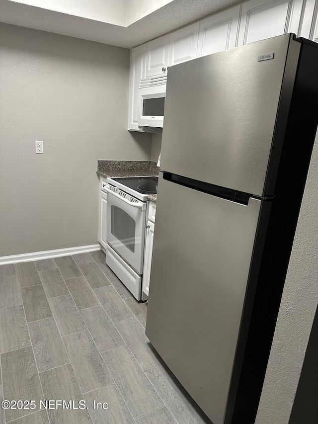 kitchen with white appliances and white cabinets