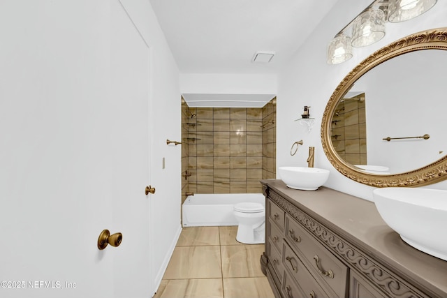 full bathroom with toilet, tiled shower / bath combo, tile patterned flooring, and vanity