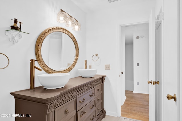 bathroom with vanity and hardwood / wood-style flooring