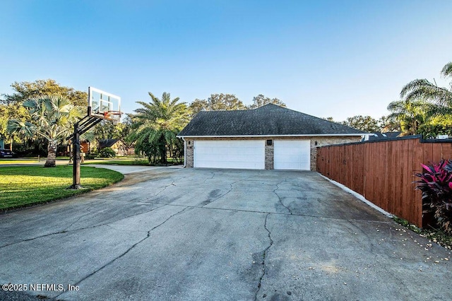 view of side of property with a garage and a lawn