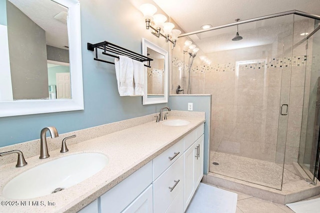 bathroom featuring vanity, walk in shower, and tile patterned flooring