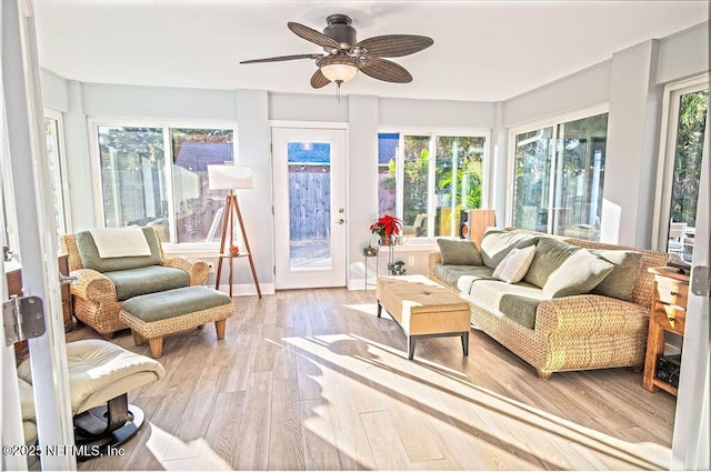 sunroom / solarium featuring ceiling fan