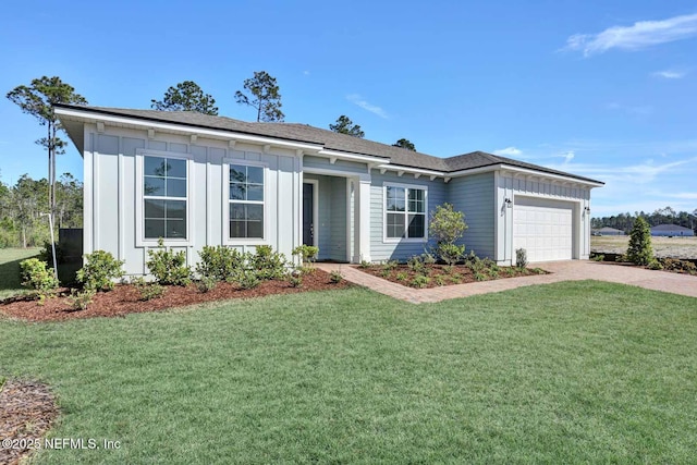 single story home featuring a garage, decorative driveway, board and batten siding, and a front lawn