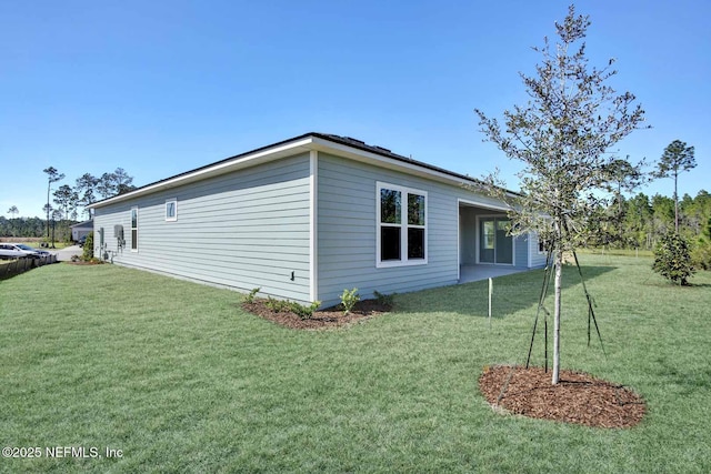 view of side of home with a lawn