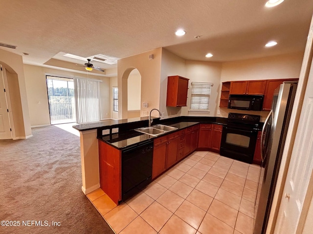 kitchen with black appliances, sink, kitchen peninsula, ceiling fan, and light colored carpet